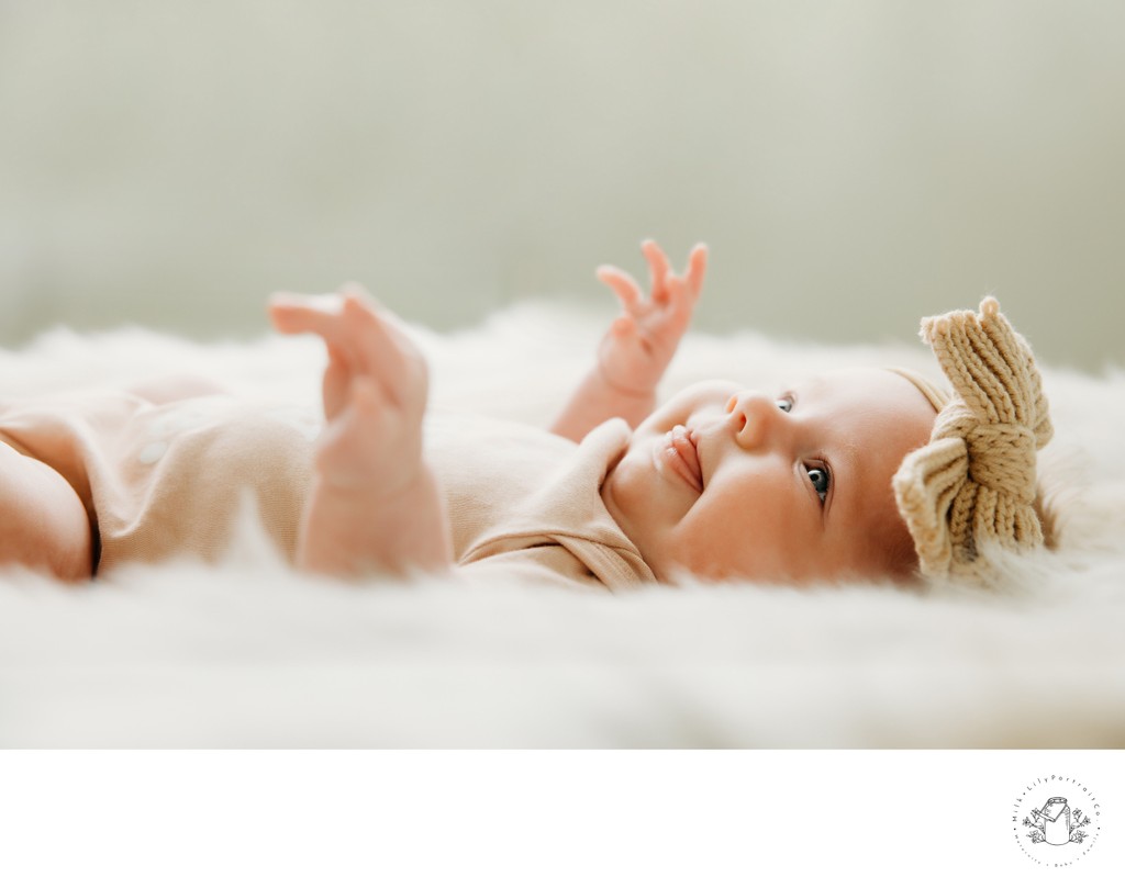 Newborn Smiling on her Back During a Studio Session