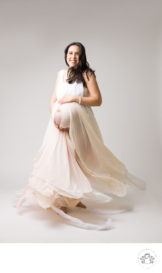 maternity photo shoot twirling fabric and radient smile