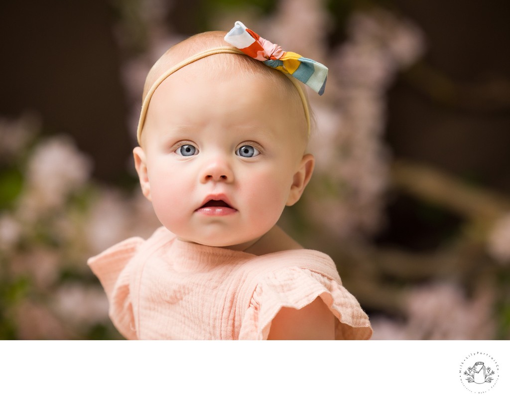 adorable baby with bow on her head