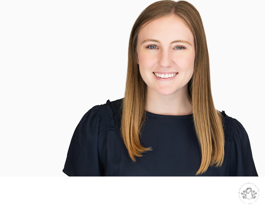 corporate headshot of a woman with a radiant smile