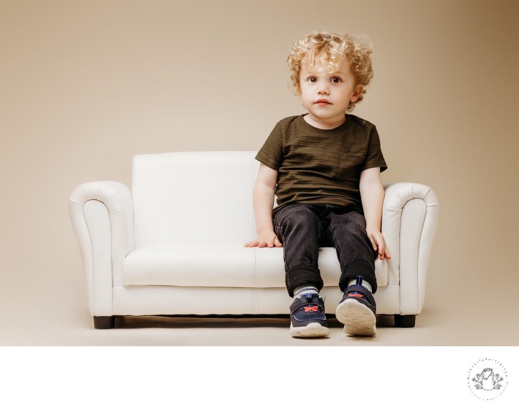 Blonde toddler on white couch