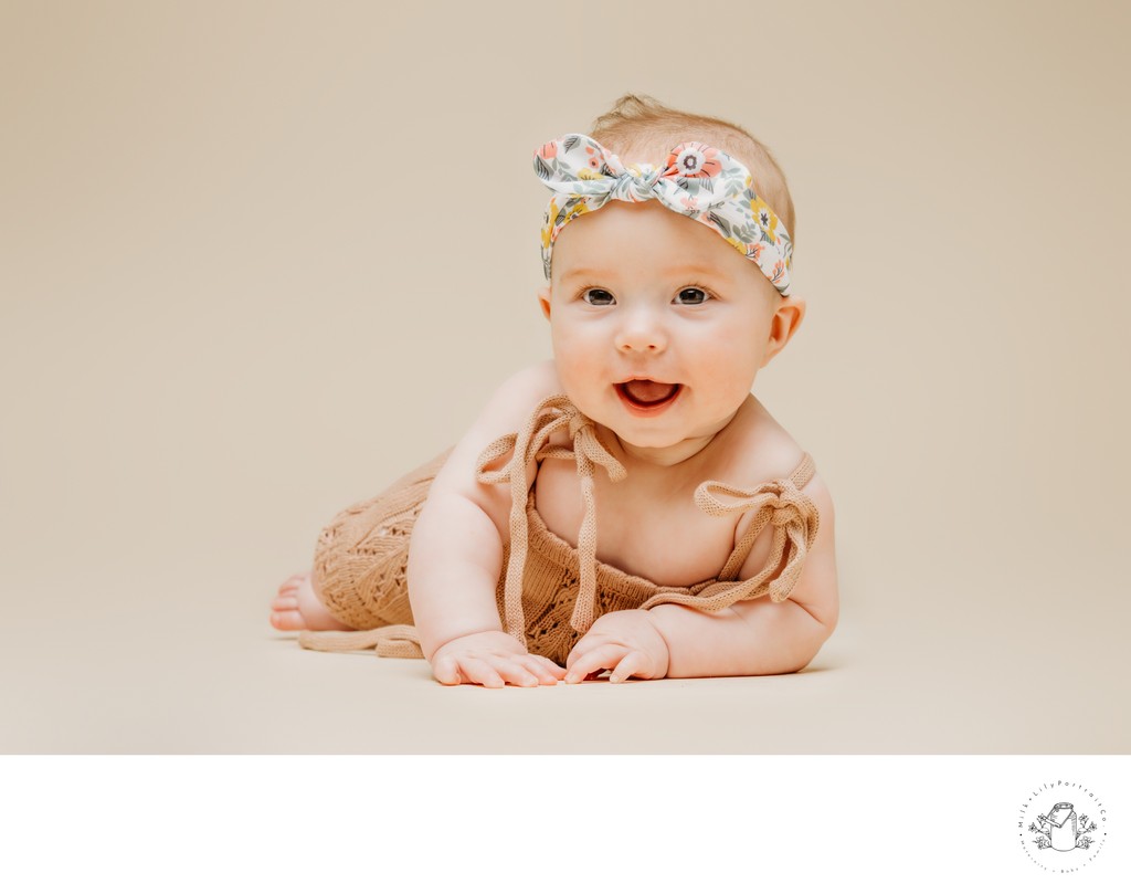 Happy baby wearing headband portrait session