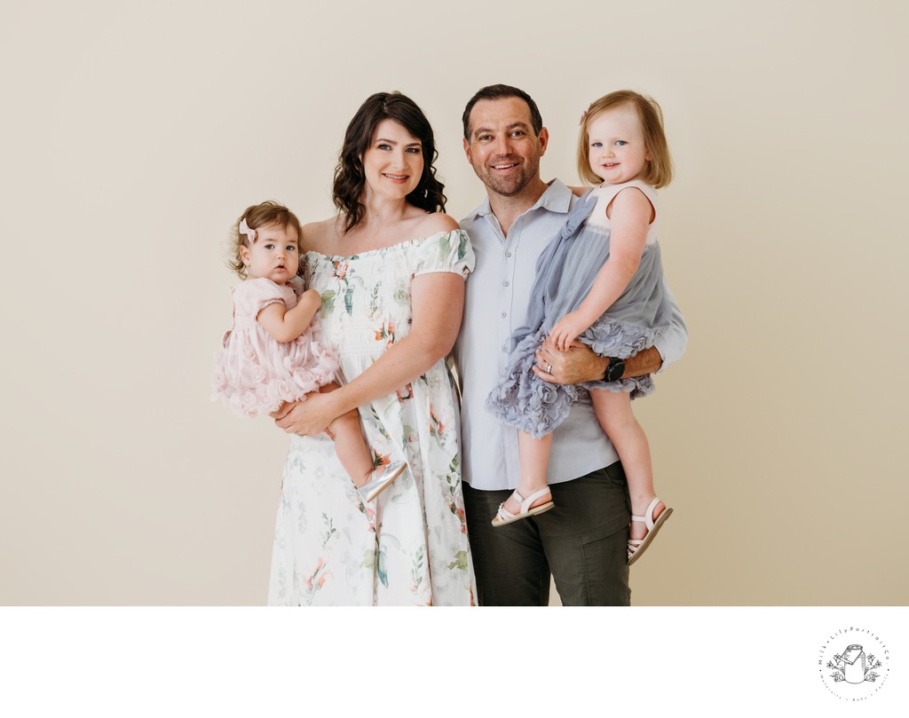 Happy family session in studio with beige backdrop