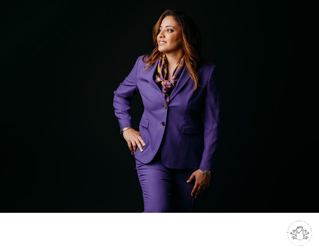 business woman in purple suit black backdrop