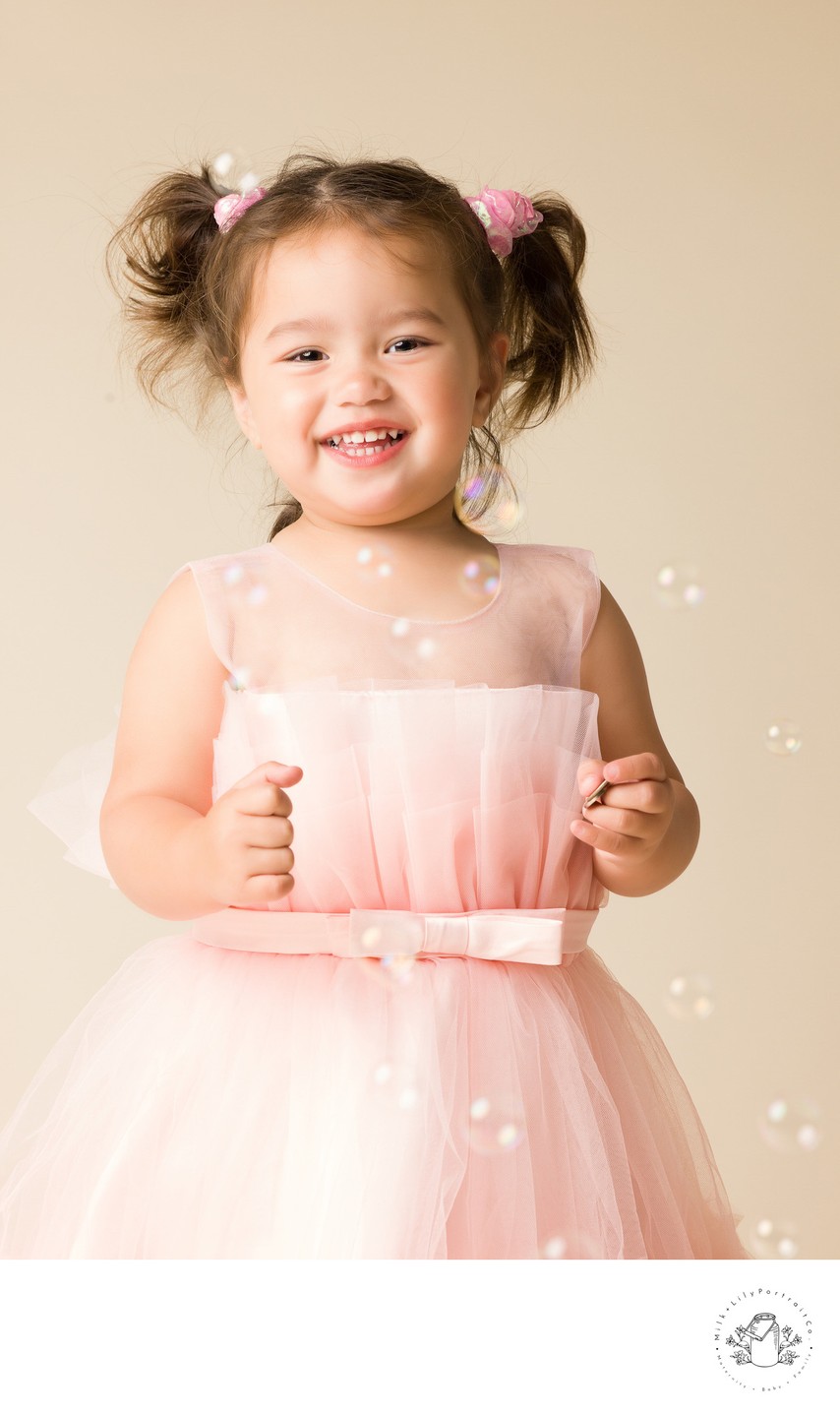 little girl photo shoot with bubbles pink dress