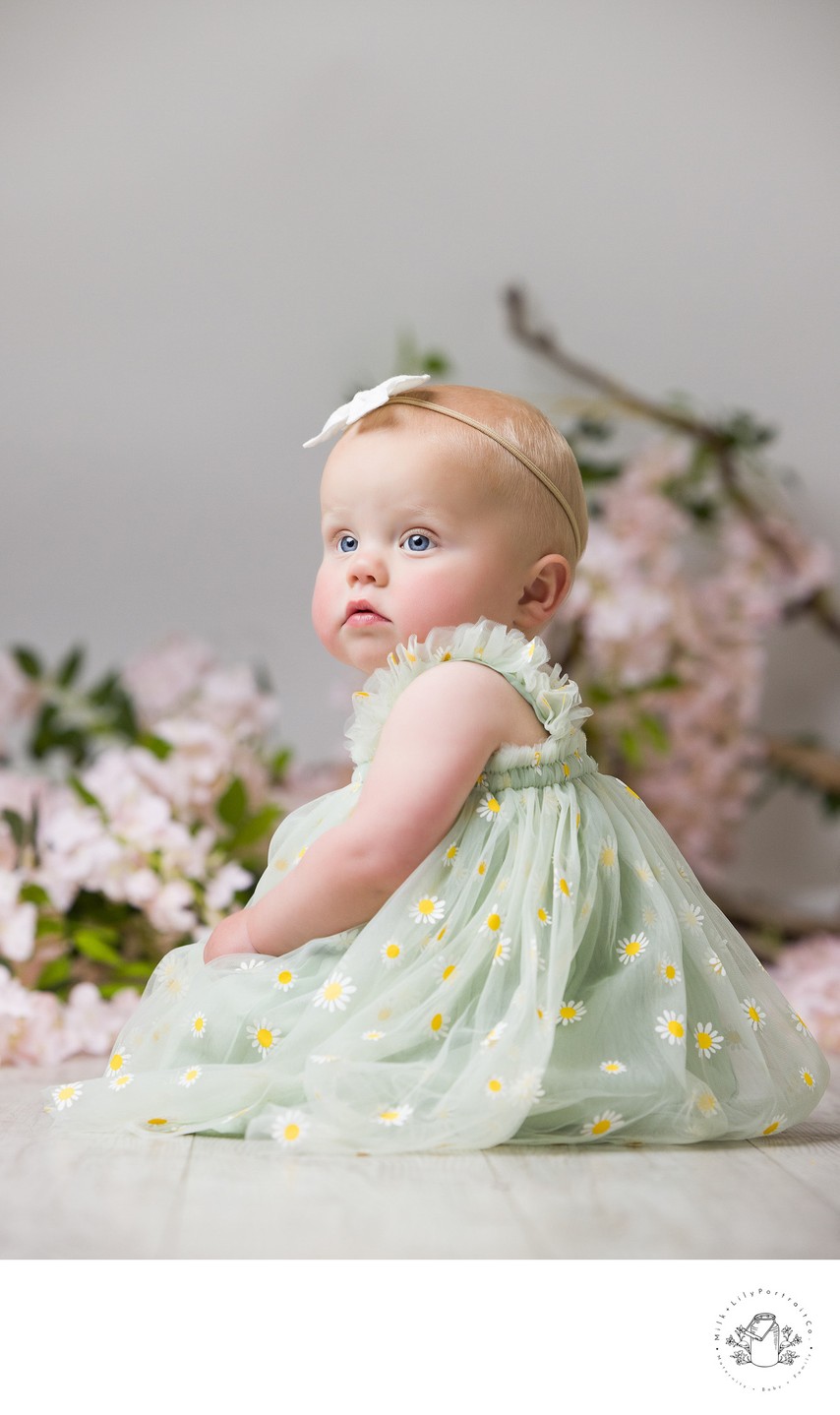 Delicate baby portrait with fresh wildflowers