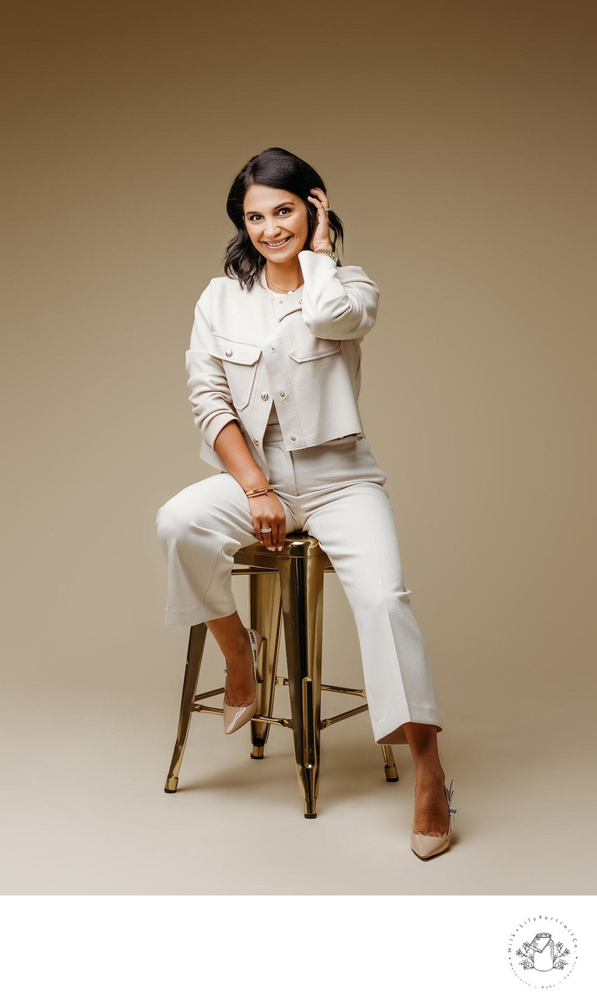 Cream backdrop gold stool headshot session