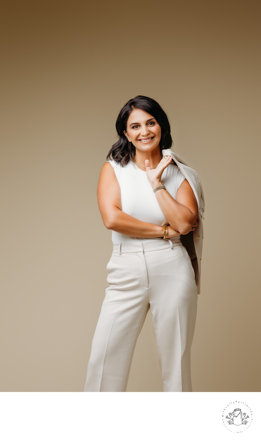 beige backdrop woman in white suit branding session 