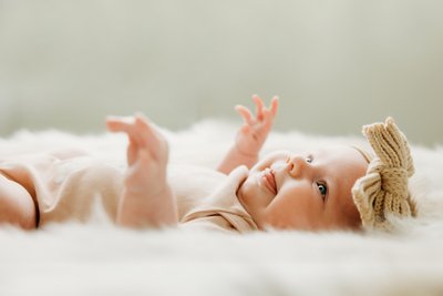 Newborn Smiling on her Back During a Studio Session