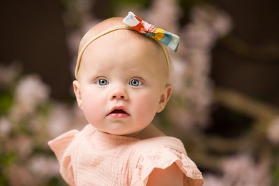 adorable baby with bow on her head