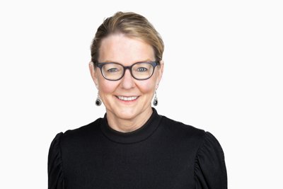 Corporate female executive headshot with glasses