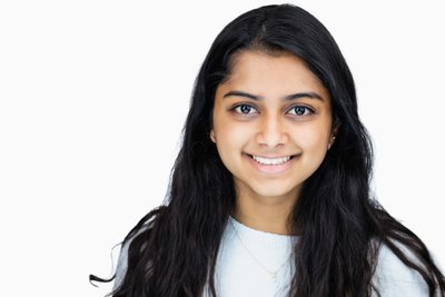 corporate headshot of an indian woman smiling