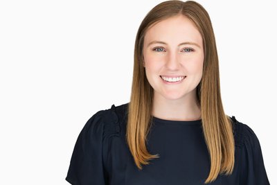 corporate headshot of a woman with a radiant smile