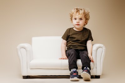 Blonde toddler on white couch