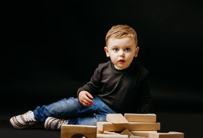 toddler boy portrait black backdrop