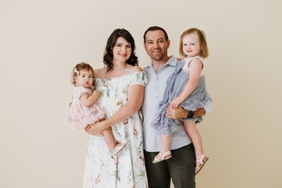 Happy family session in studio with beige backdrop