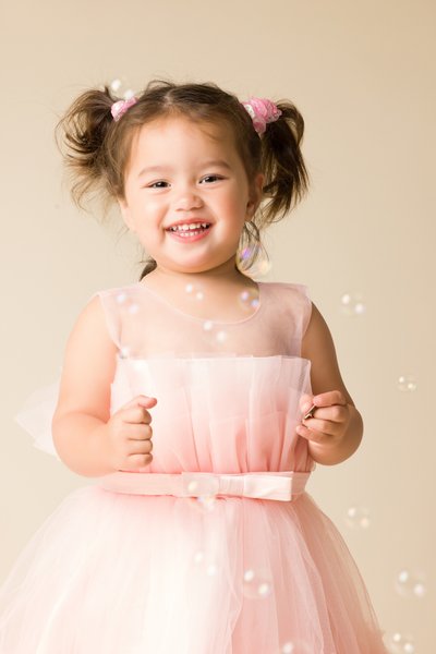 little girl photo shoot with bubbles pink dress