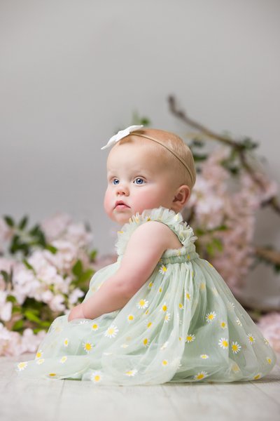 Delicate baby portrait with fresh wildflowers