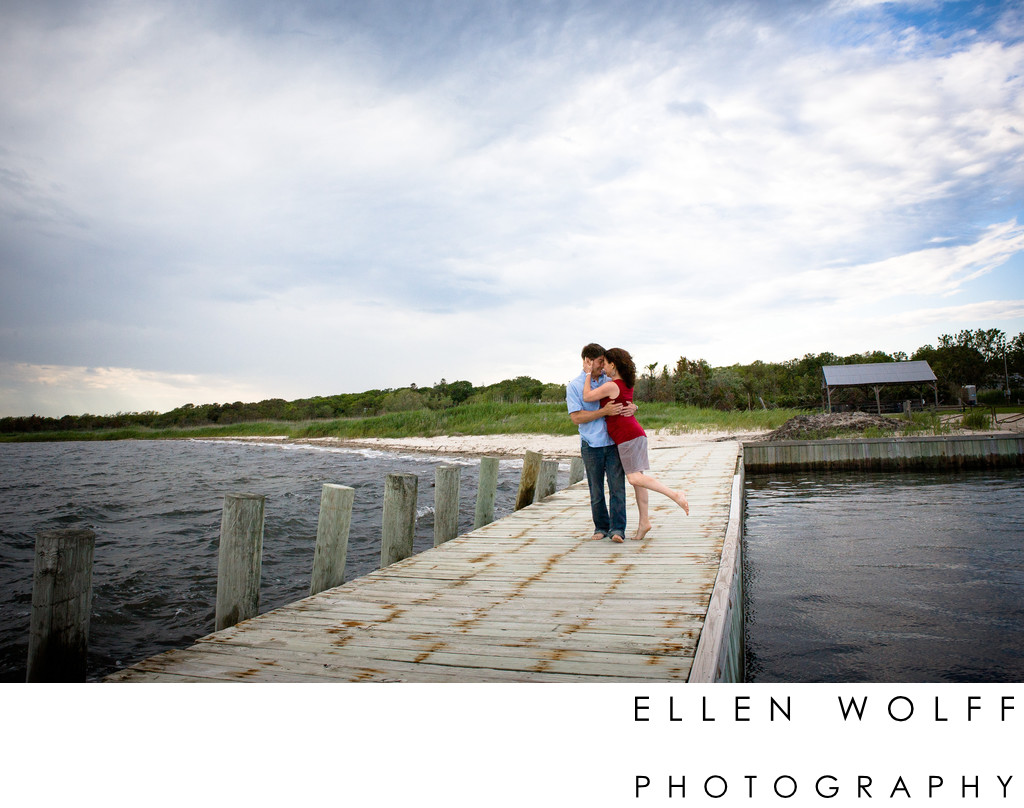 engagement photo on a dock near the beach