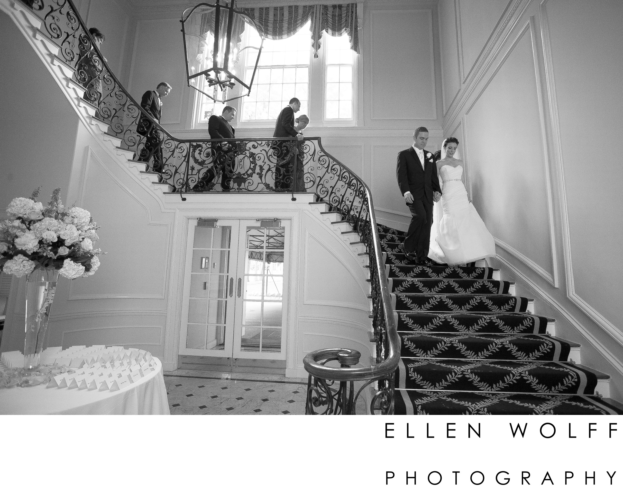 bride and groom descending the stairs at muttontown cc Ellen Wolff