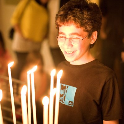 bar mitzvah portrait with candle light from the cake