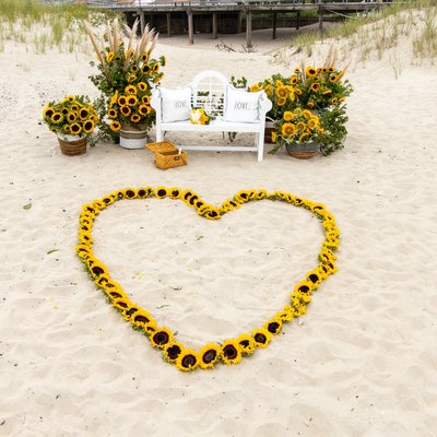 sunflower floral decor for a beach marriage proposal