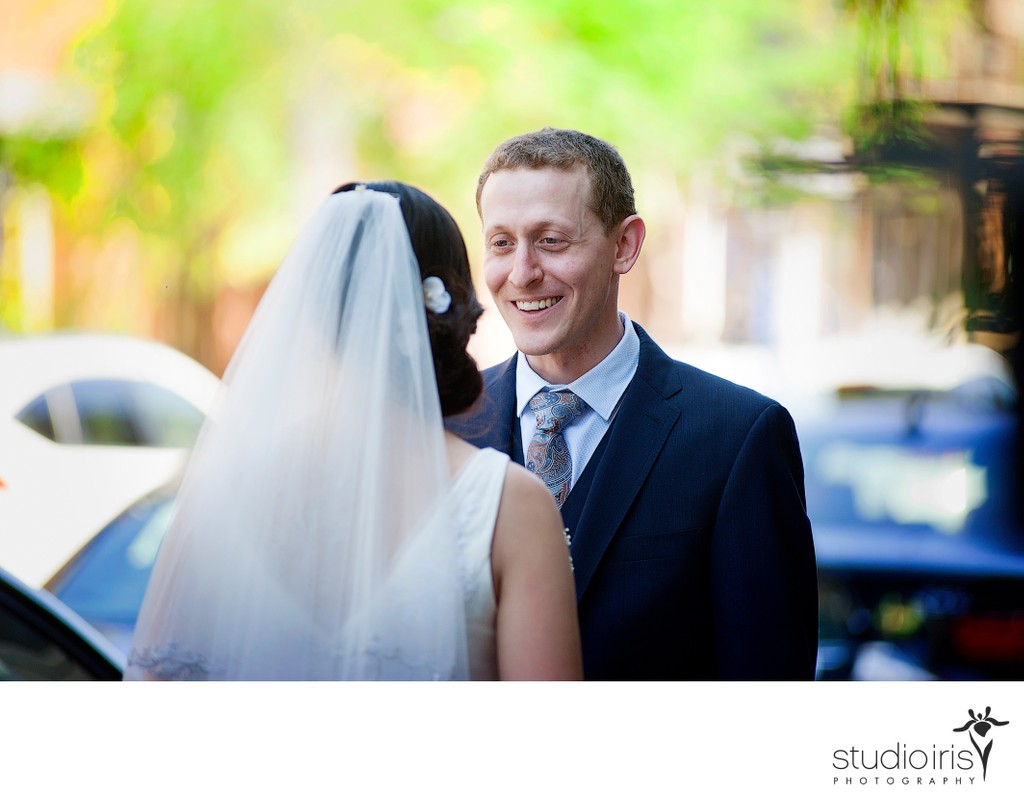 Groom gazing at bride on the street in Montreal before Jewish wedding at Bagg Street Synagogue