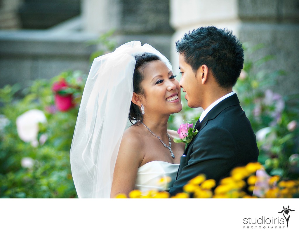 Bride and groom surrounded by flowers during their Vietnamese wedding in montreal