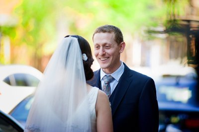 Groom gazing at bride on the street in Montreal before Jewish wedding at Bagg Street Synagogue