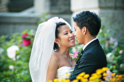 Bride and groom surrounded by flowers during their Vietnamese wedding in montreal
