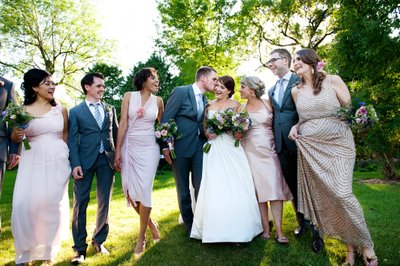 Newlyweds walking with bridal party in garden at Hudson wedding