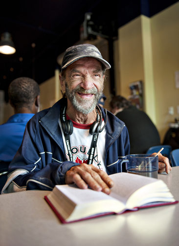 Ramond Carrier enjoys a free cup of coffee and place to read his book at Montreal's Café Mission