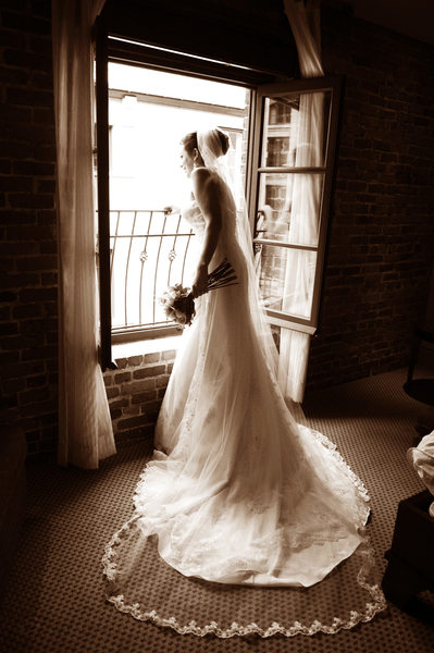 Bride framed by window at Hotel Nelligan in Montreal