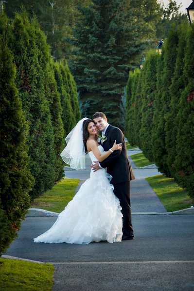 Newlyweds embracing after their outdoor wedding at Golf Saint Raphael 