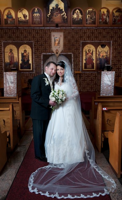 Bride and groom standing in front of alter after their wedding at Première Eglise Évangélique Arménienne in Montreal. 