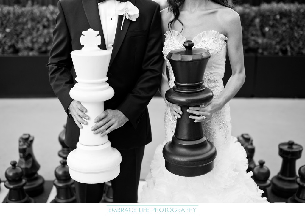 Bride and Groom Holding Giant Chess Pieces