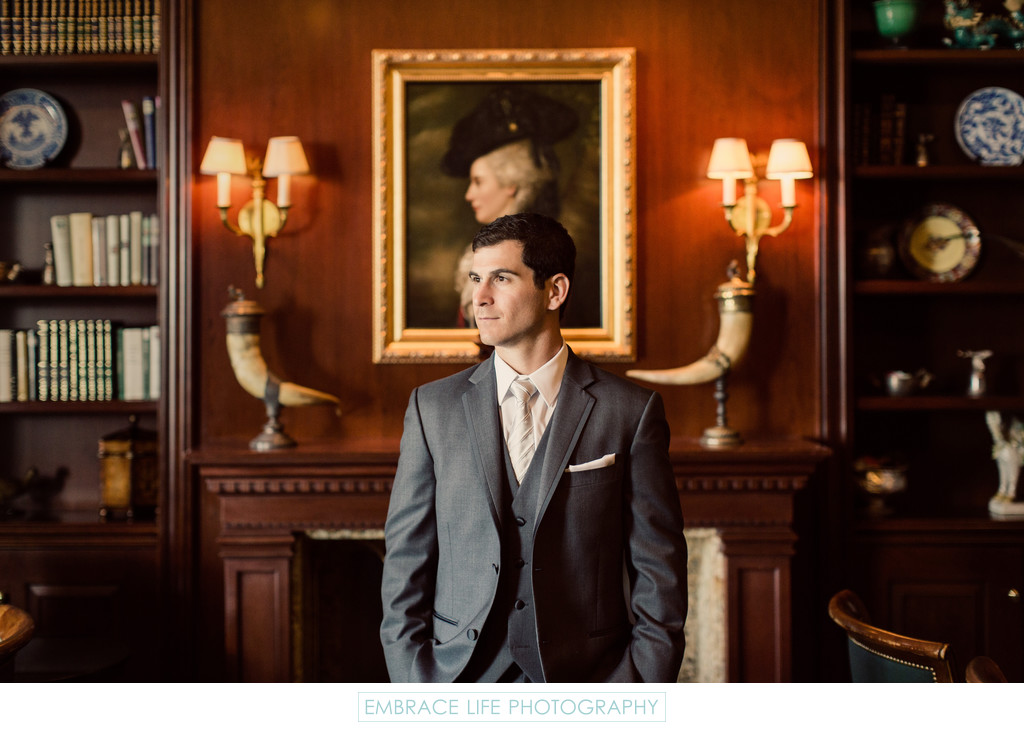 Handsome Groom Poses in Historic Themed Bar