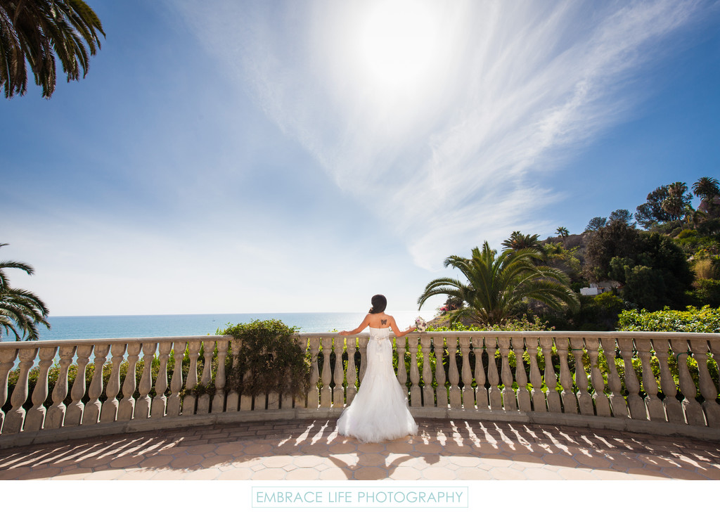 Bride Facing Pacific Ocean at Balustrade