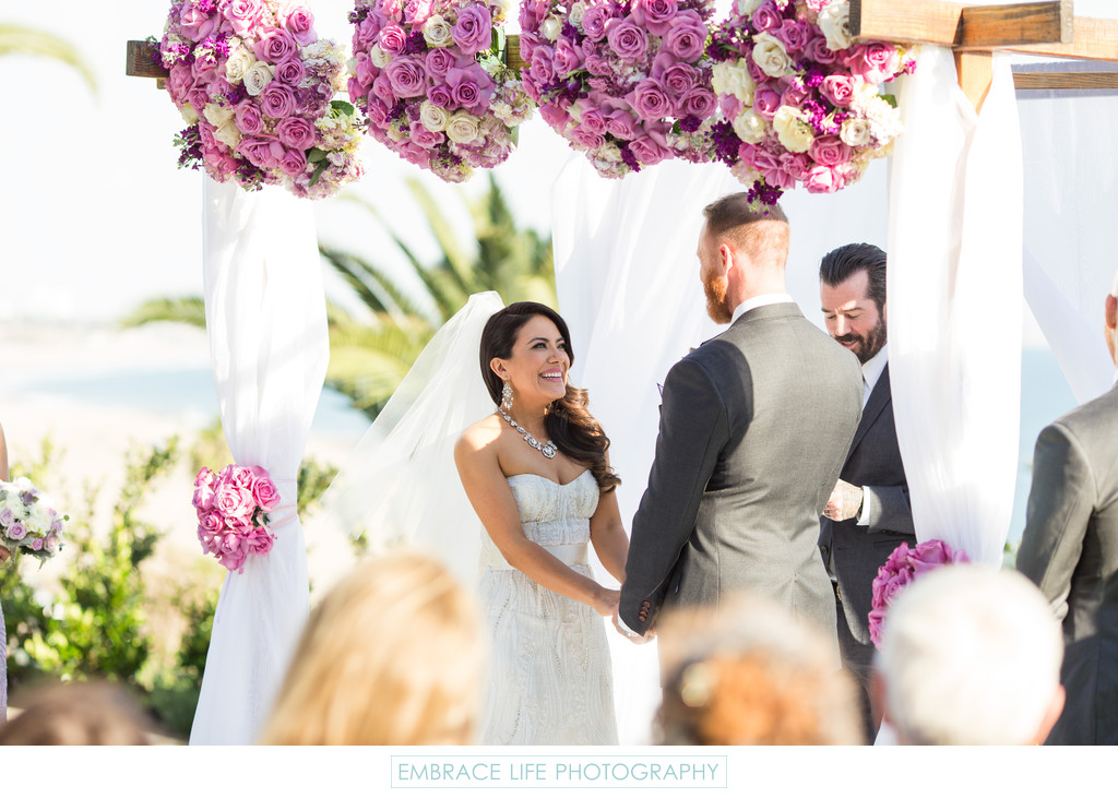 Exchanging Wedding Vows Under Lavender Rose Canopy