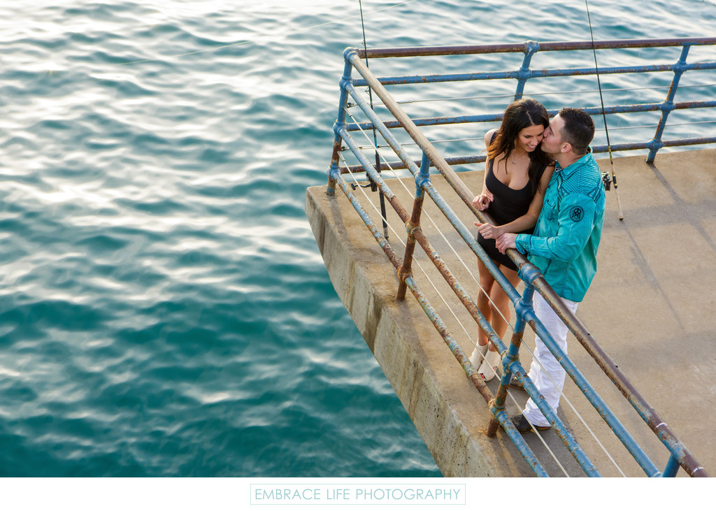 Engaged Couple Kissing at the end of Santa Monica Pier