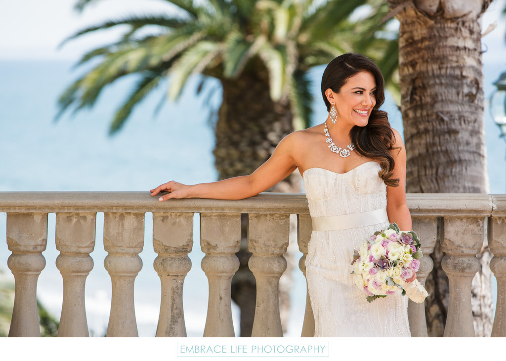 Bride Standing at Railing with Ocean View