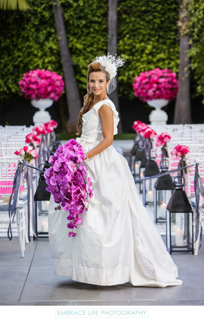 Bride Poses with Cascading Purple Orchid Bouquet