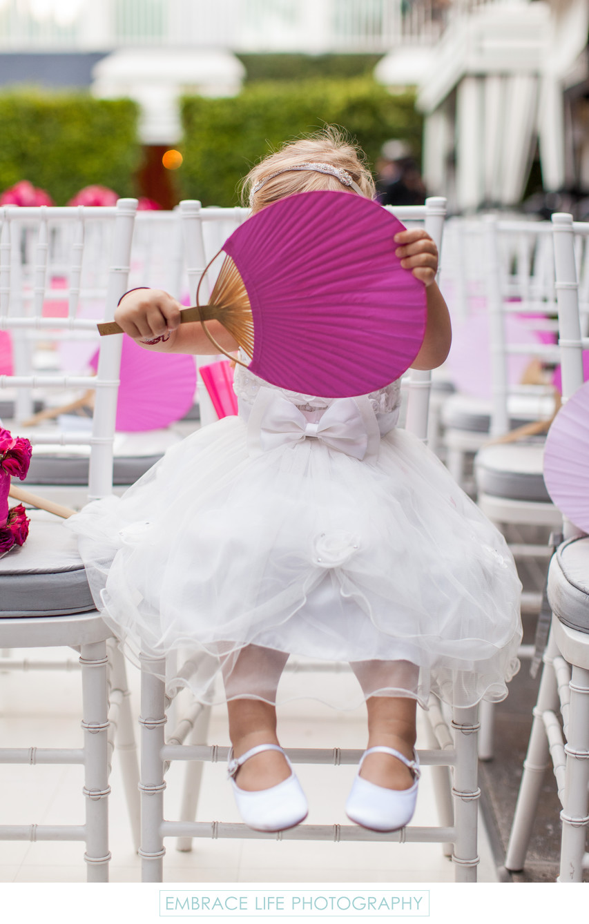 Flower Girl Hides Behind Large Hand Fan