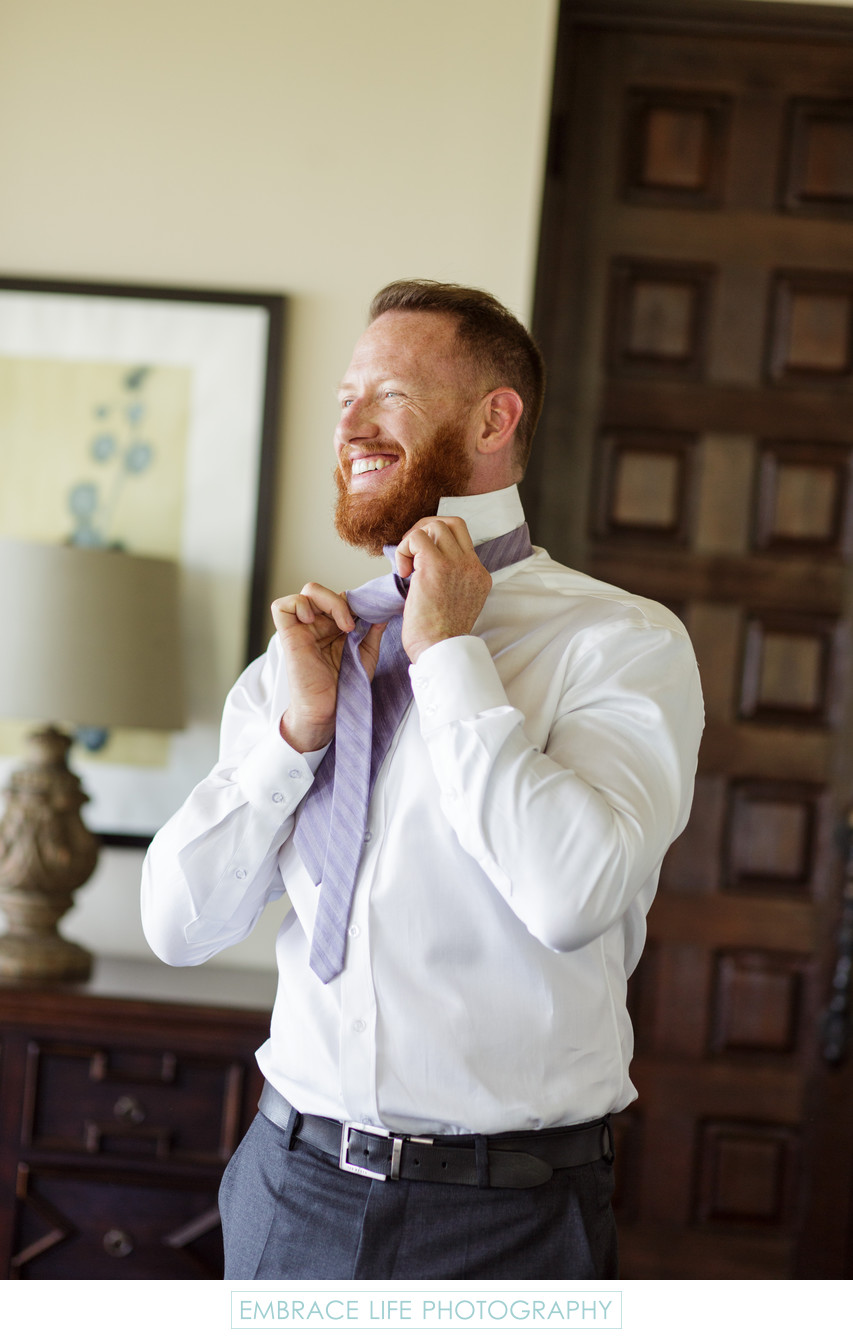Groom Getting Ready for His Wedding With Lavender Tie