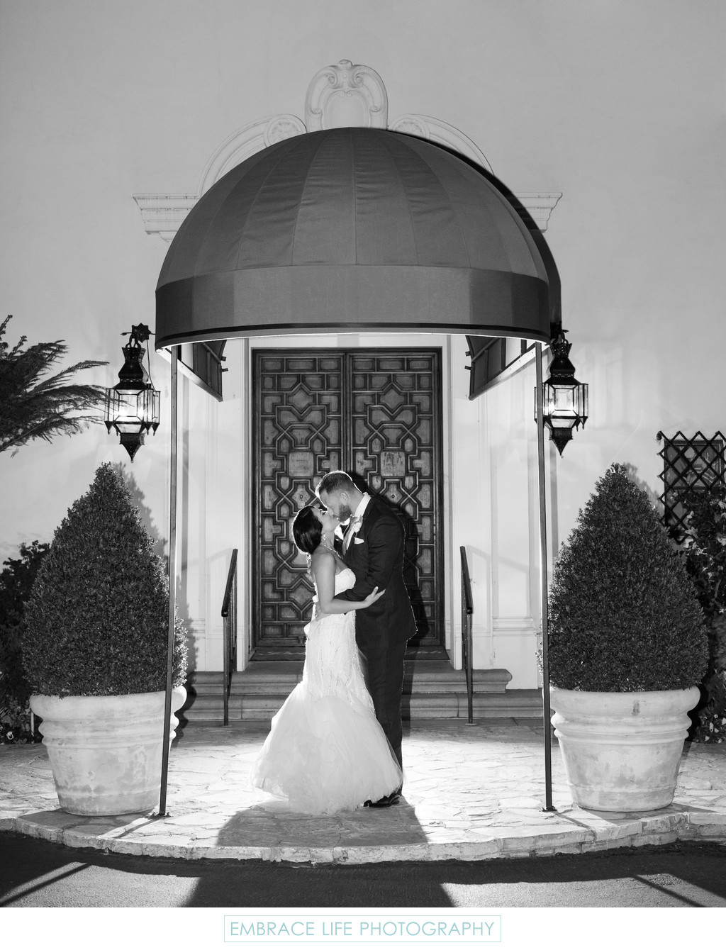 Couple Kissing Outside of Grand Entry Doors
