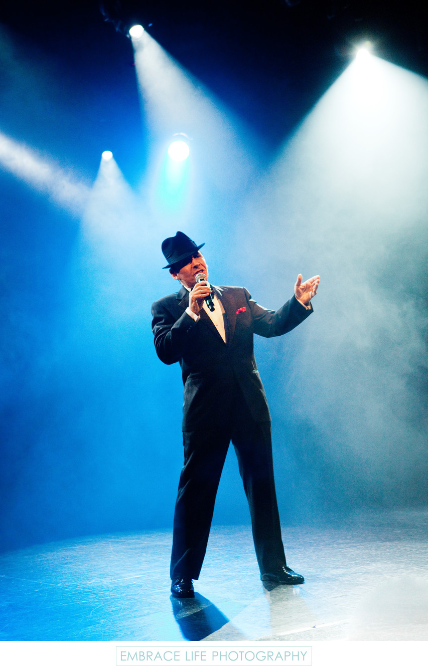 Frank Sinatra Impersonator Singing Under Stage Lighting