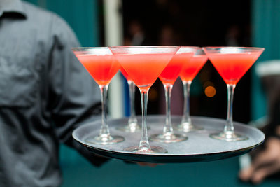 Tray of Pink and Orange Cocktails Being Served