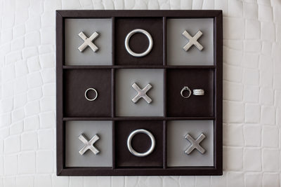 Creative Wedding Ring Photograph on Tic-Tac-Toe Board