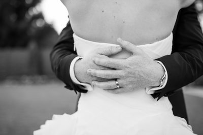 Groom Wraps Bride in His Arms