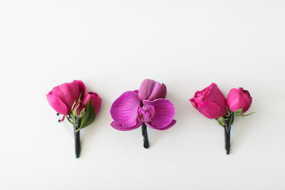 Purple Orchid and Fuchsia Rose Boutonnieres
